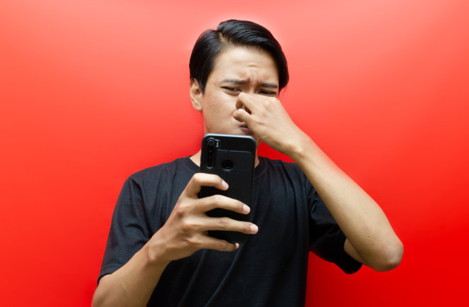 boy-smelling-foul-phone