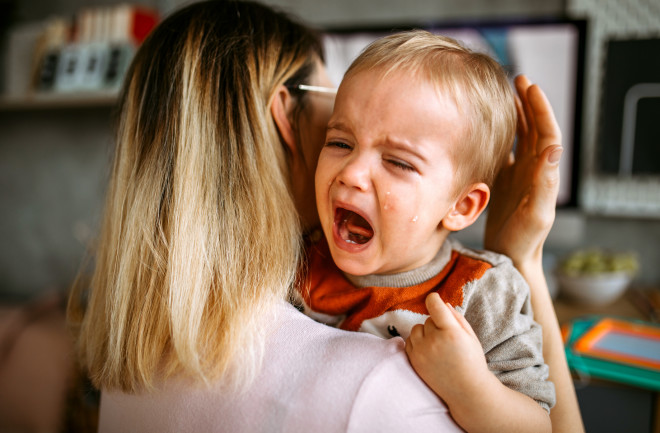 Crying-child-in-mothers-arms