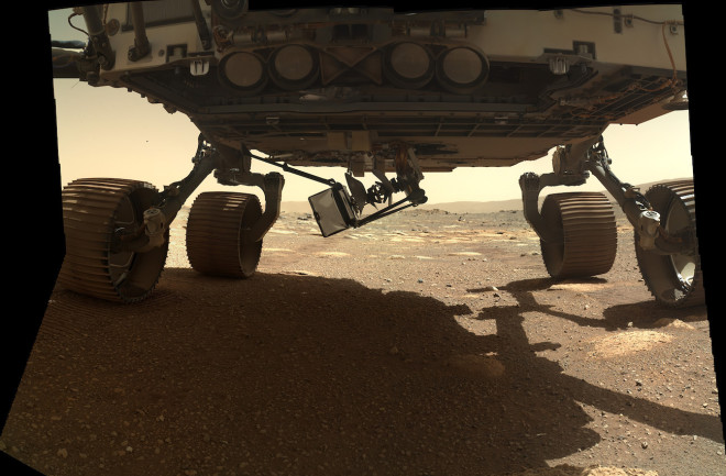 The Ingenuity helicopter is being lowered — very carefully! — to the Martian surface beneath the belly of the Perseverance rover. (Credit: NASA/JPL/Caltech/Ken Kremer)