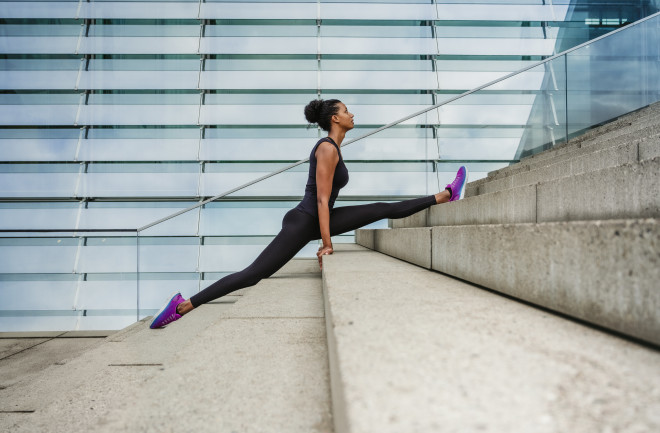 Woman doing splits on steps, Berlin/Germany