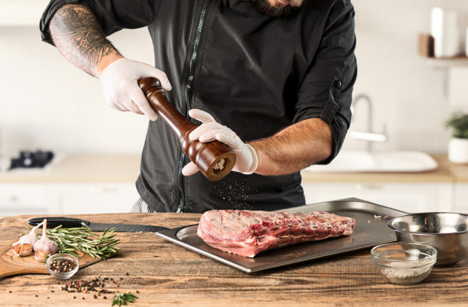 Man cooking meat for carnivore diet