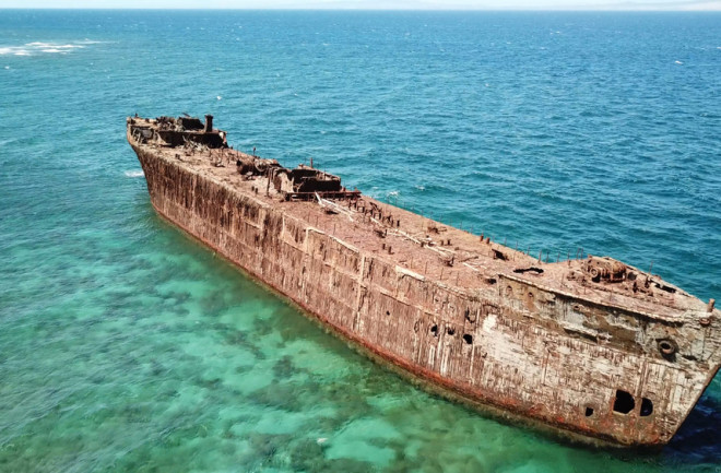 A rusty shipwreck off the coast of ShipWreck Beach on the Island of Lanai