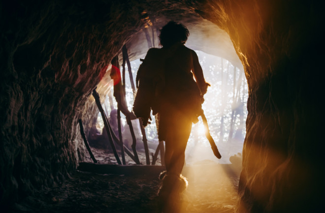 ancient human leaving a cave 
