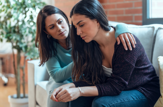 two women one supporting the other with depression